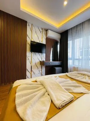 a bedroom with a bed with towels on it at Meridiani Taksim Hotel in Istanbul