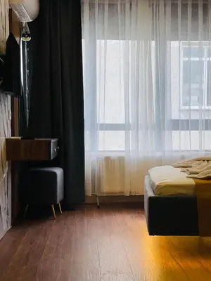 a bedroom with a bed and a window with a chair at Meridiani Taksim Hotel in Istanbul