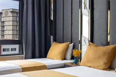 a hotel room with two beds and a window at Meridiani Taksim Hotel in Istanbul