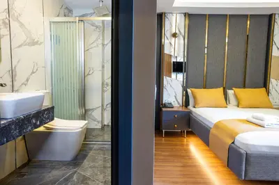 a bedroom with a bed and a sink and a tub at Meridiani Taksim Hotel in Istanbul