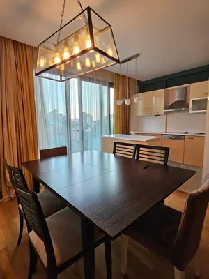 a kitchen and dining room with a table and chairs at TAKSiM PERFECT RESiDENCE, 3 BEDROOMS, 140 M2, POOL GYM SAUNA ACCESS in Istanbul
