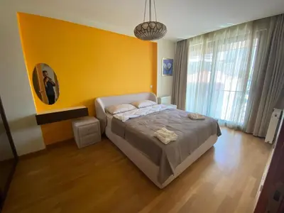 a bedroom with a bed and a yellow wall at TAKSiM PERFECT RESiDENCE, 3 BEDROOMS, 140 M2, POOL GYM SAUNA ACCESS in Istanbul