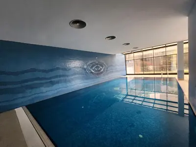 a swimming pool with a painting on the wall at Taksim Square Residence, Two bedrooms, pool sauna gym in Istanbul