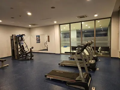 a gym with treadmills and machines in a room at Taksim Square Residence, Two bedrooms, pool sauna gym in Istanbul