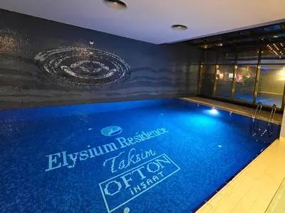 a swimming pool with a sign on the side of a building at Taksim Square Residence, Two bedrooms, pool sauna gym in Istanbul
