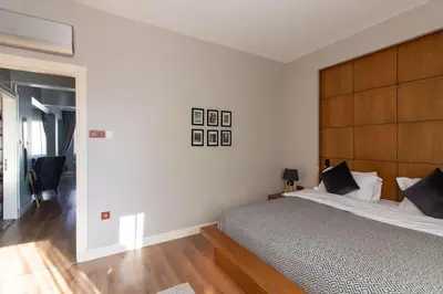 a bedroom with a large bed with a wooden headboard at Exclusive Vibrant 3BR Duplex w Terrace in Kadıköy! in Istanbul