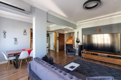 a living room with a couch and a large screen tv at Exclusive Vibrant 3BR Duplex w Terrace in Kadıköy! in Istanbul
