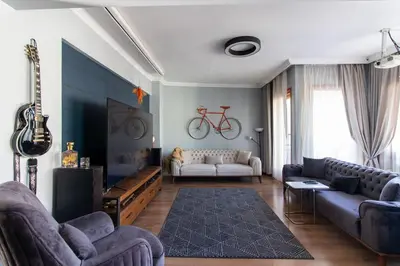 a living room with a couch and a bike on the wall at Exclusive Vibrant 3BR Duplex w Terrace in Kadıköy! in Istanbul