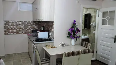 a kitchen with a small table with purple flowers on it at BeyazitHan Suites Old City in Istanbul