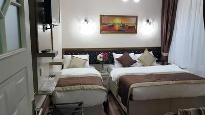 two beds in a hotel room with flowers on the wall at BeyazitHan Suites Old City in Istanbul