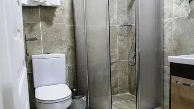 a bathroom with a toilet and a shower at BeyazitHan Suites Old City in Istanbul