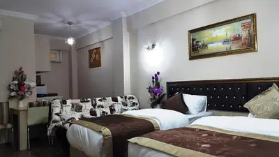 a hotel room with two beds and a couch at BeyazitHan Suites Old City in Istanbul