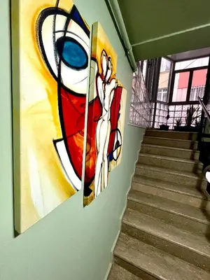 a painting of a woman on a wall next to stairs at Cosy flat nearTaksim/Nişantaşi in Istanbul