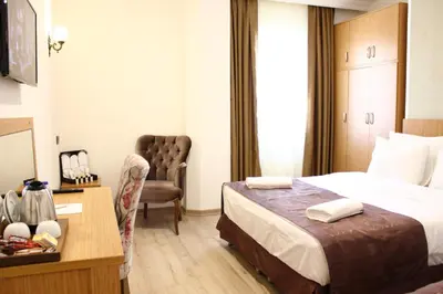 a hotel room with a bed and a desk at Melidium Hotel in Beylikduzu