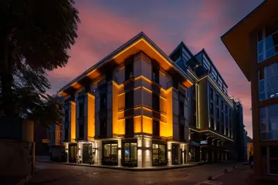 an office building with a sunset in the background at Hotel Ravi in Istanbul