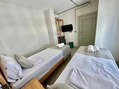 a hotel room with two beds and a tv at Elegance House Hotel in Istanbul