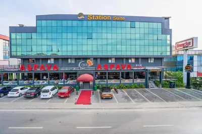 a parking lot with cars parked in front of a building at 216 Station Suite Gebze in Gebze