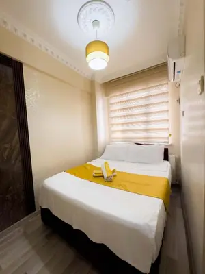 a bedroom with a bed with a phone on it at Öz Dünya Suites Apartment in Istanbul