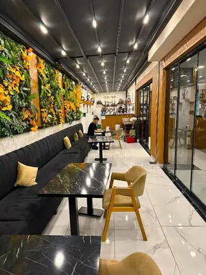 a restaurant with couches and tables and plants on the wall at Mays Royal Hotel in Istanbul