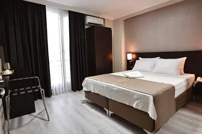 a bedroom with a large bed in a room at Mays Royal Hotel in Istanbul