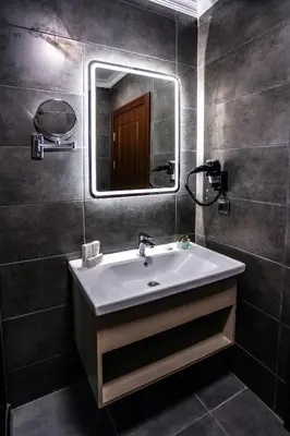 a bathroom with a sink and a mirror at Mays Royal Hotel in Istanbul