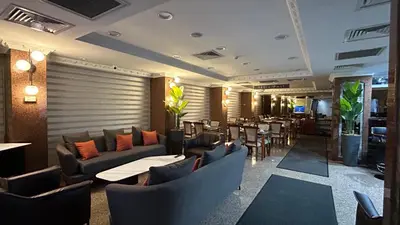 a restaurant with couches and tables and chairs at Grand Hotel Seferoğlu in Istanbul