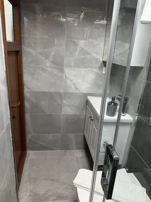 a bathroom with a shower with a toilet and a sink at Palladium APART Hotel in Istanbul