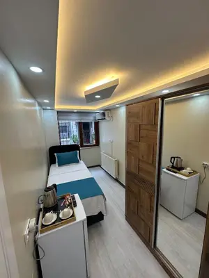 a small room with a bed and a bathroom at Palladium APART Hotel in Istanbul