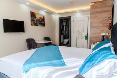 a bedroom with a bed and a flat screen tv at Palladium APART Hotel in Istanbul