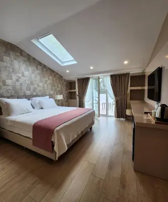 a bedroom with a large bed and a television at Villa No 44 in Darıca