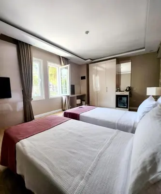 a hotel room with two beds and a television at Villa No 44 in Darıca