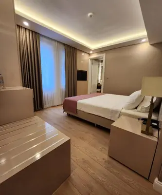 a hotel room with a bed and a couch at Villa No 44 in Darıca