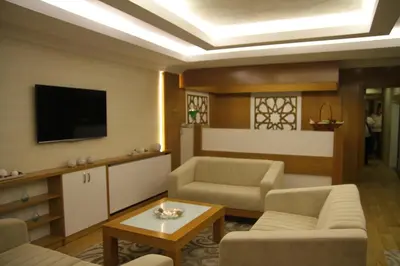 a living room with a couch and a tv at Besiktas Otel in Istanbul