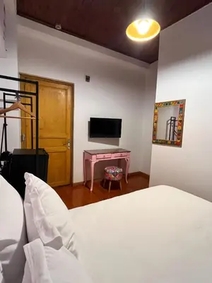 a bedroom with a bed and a desk with a television at Dimora Hotel Kadıköy in Istanbul