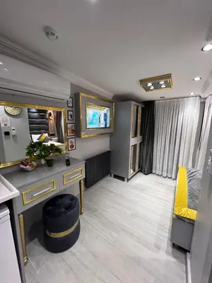 a room with a vanity and a tv in it at TAKSİM LARİSSA RESİDENCE in Istanbul