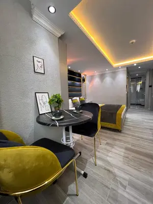 a room with a bed and a table and chairs at TAKSİM LARİSSA RESİDENCE in Istanbul