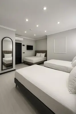 a bedroom with two beds and a mirror at Park Hotel & Private Transportation İstanbul Airport-By Loft in Arnavutköy
