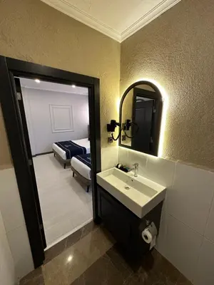 a bathroom with a sink and a mirror and a bed at Park Hotel & Private Transportation İstanbul Airport-By Loft in Arnavutköy