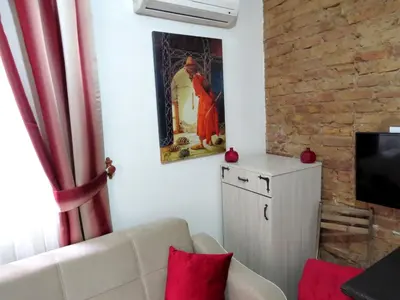a living room with a couch and a painting on the wall at Istanberry - Berry Life Apartments in Istanbul
