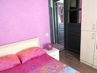 a bedroom with a pink wall and a bed with two pillows at Istanberry - Berry Life Apartments in Istanbul