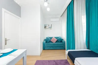 a bedroom with a blue couch in a room at Istanbul House in Istanbul