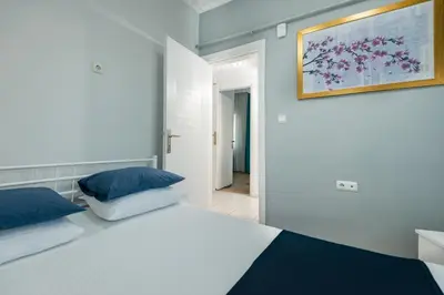 a bedroom with a white bed and a painting on the wall at Istanbul House in Istanbul