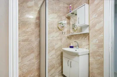 a bathroom with a white sink and a shower at Istanbul House in Istanbul