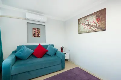 a blue couch with two red pillows in a living room at Istanbul House in Istanbul