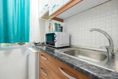 a kitchen with a sink and a microwave at Istanbul House in Istanbul