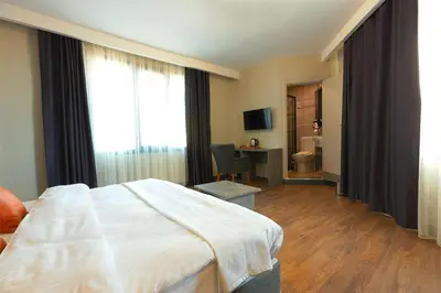 a hotel room with a large bed and a desk at Grand royal hotel in Gümüşyaka