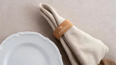 a napkin sitting on top of a white plate at Grand royal hotel in Gümüşyaka