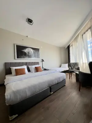 a large bedroom with a large bed and a desk at Grand royal hotel in Gümüşyaka