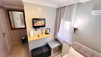 a living room with a couch and a tv on a wall at Taksim Centre Hotel in Istanbul