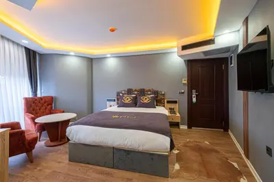 a bedroom with a king sized bed and a tv at Viv City Hotel in Istanbul